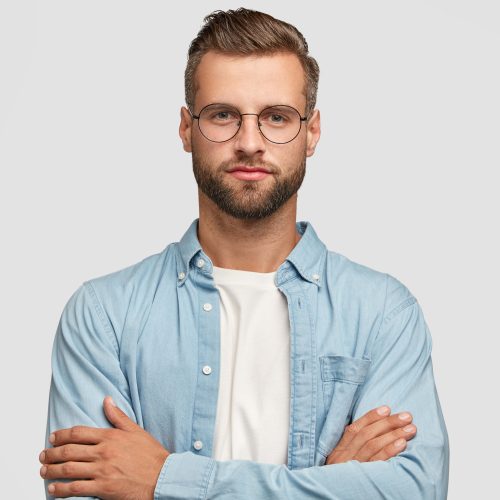 handsome-bearded-guy-posing-against-white-wall-min